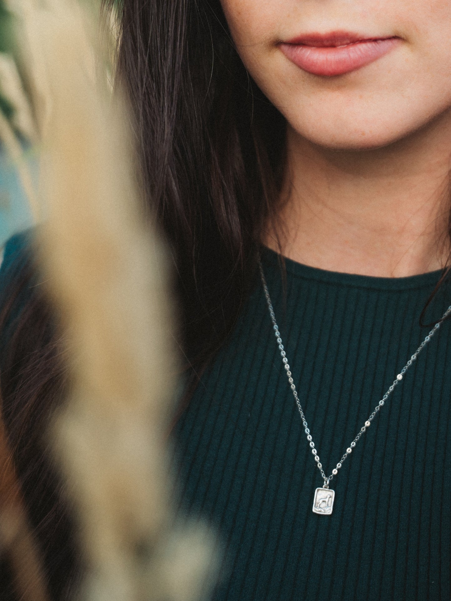 Silver pendant necklace with a mountain dog design