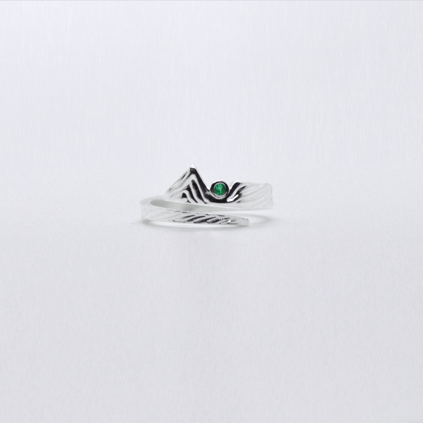 Adjustable sterling silver mountain ring with emerald