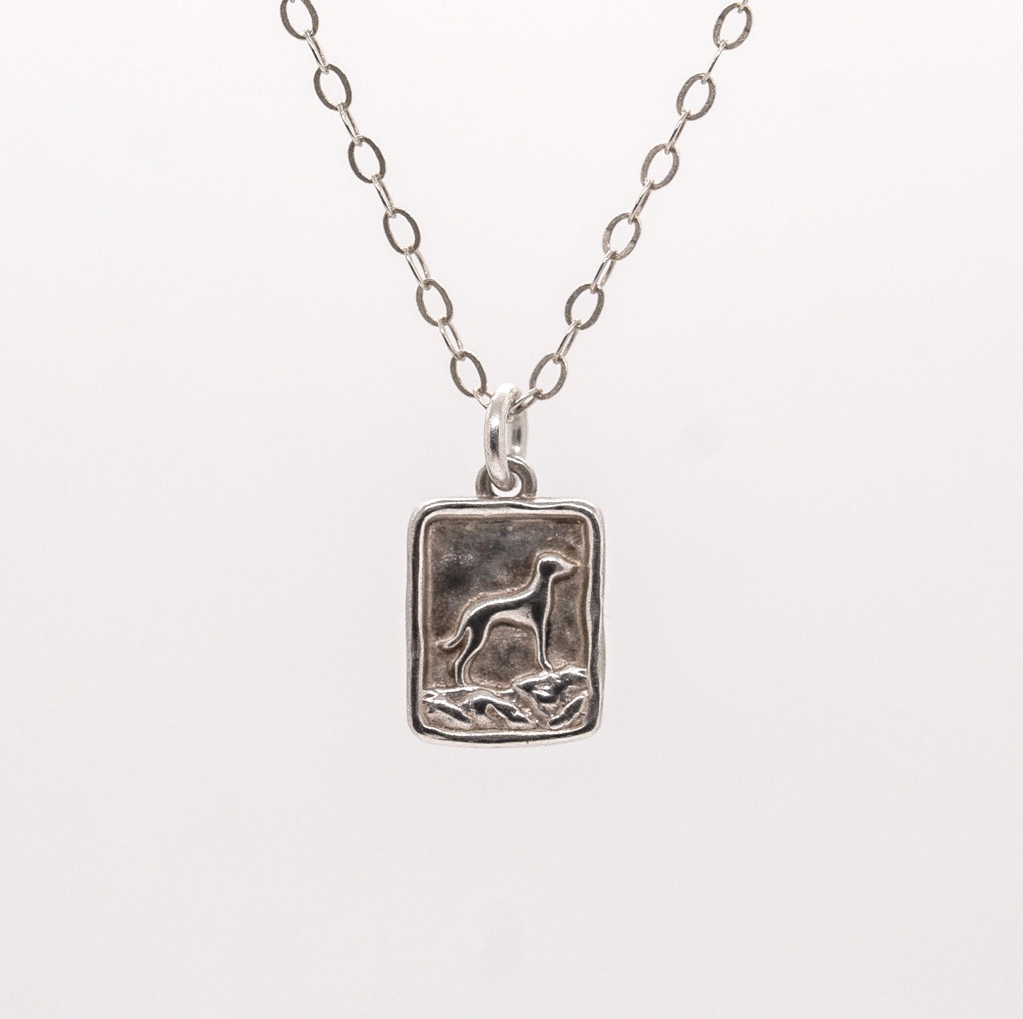 Silver pendant necklace with a mountain vizsla dog design