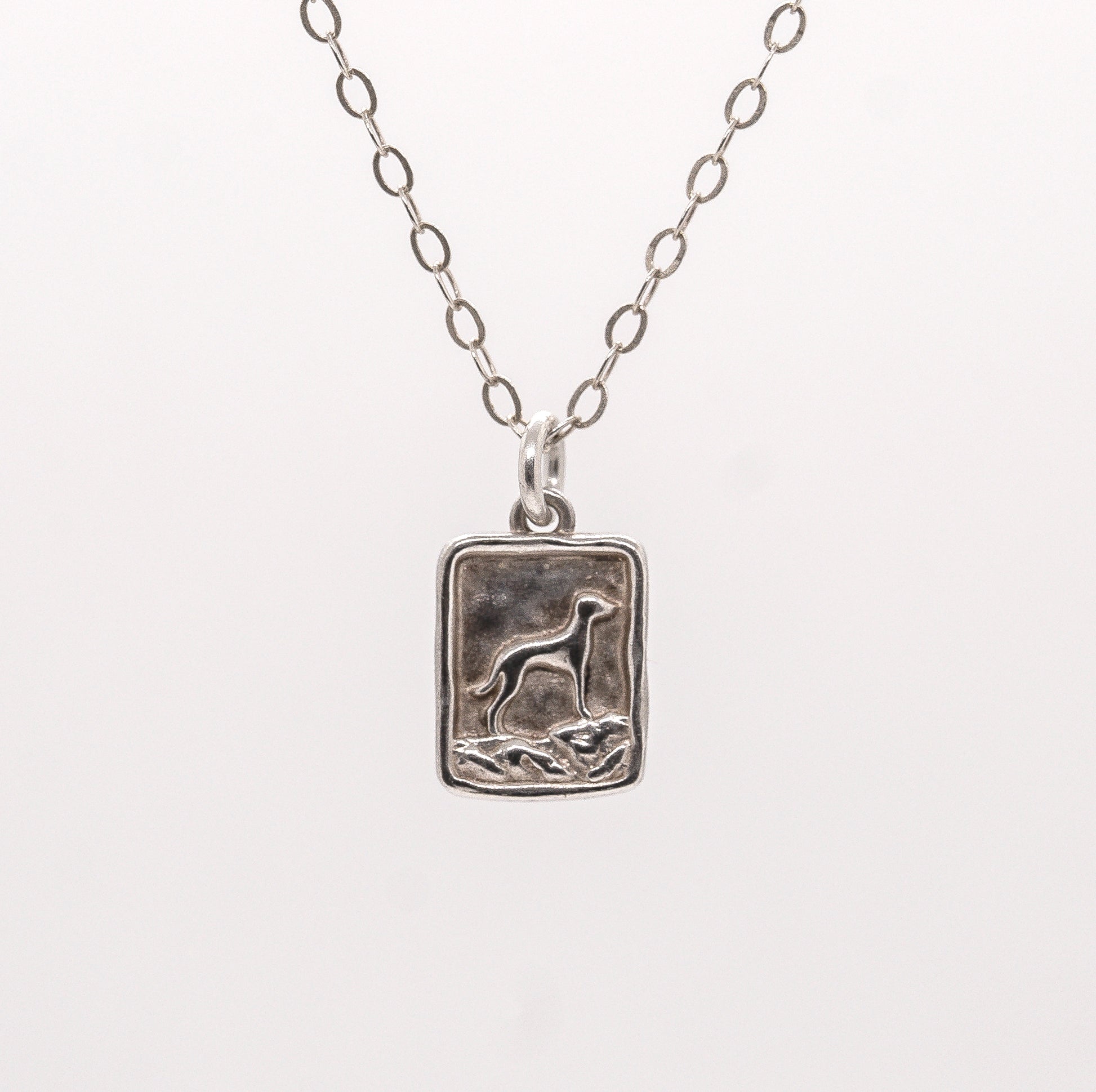 Silver pendant necklace with a mountain vizsla dog design